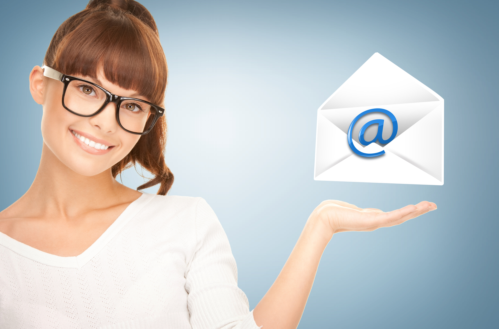young red headed woman with blue background and an envelope with the @ symbol floating above her hand